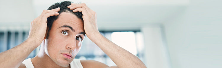 Man inspecting his side hairline