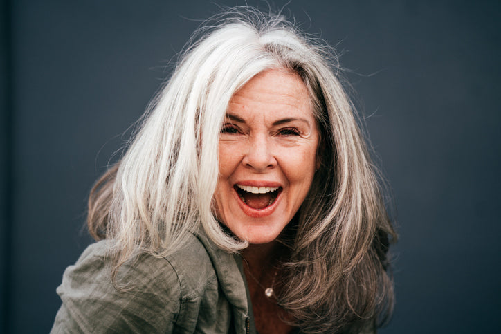 Smiling older woman with medium-length white hair