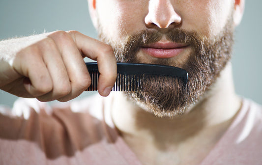 Man brushing his beard