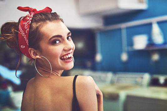 Smiling woman looking sideways, sporting a bandana look