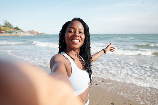 Smiling woman with braided hair on the beach