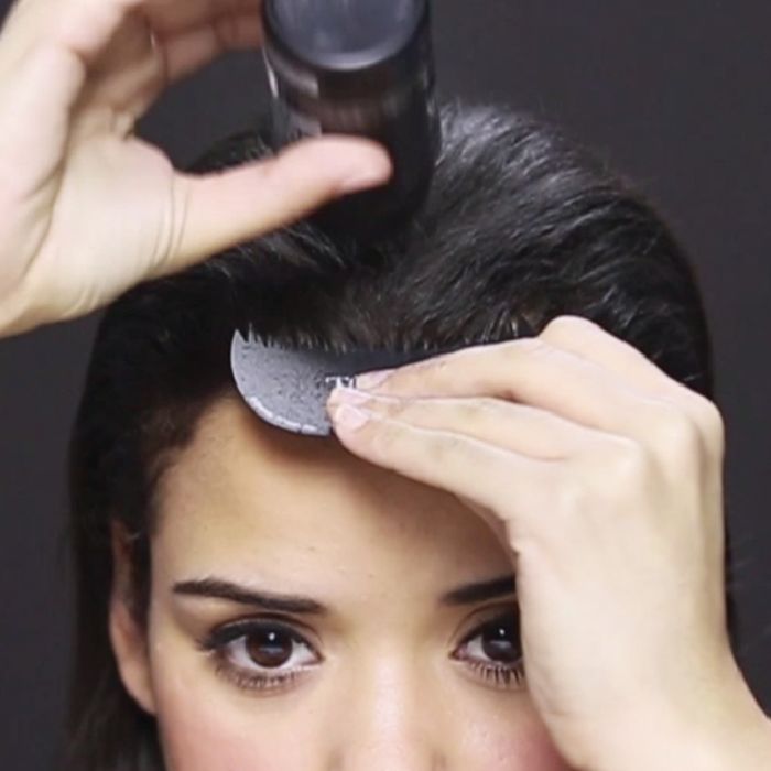 Woman Applying Toppik Hair Building Fibers with Hairline Optimizer