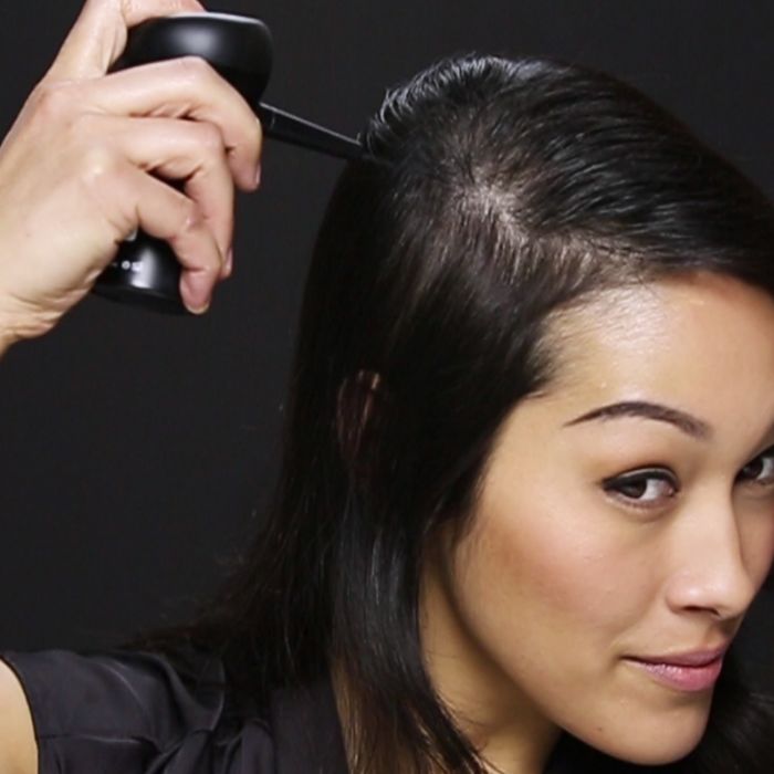 woman using Toppik hair building fiber