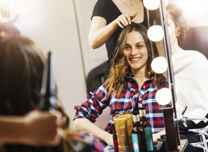 Women at beauty parlour having haircut and make up treatment