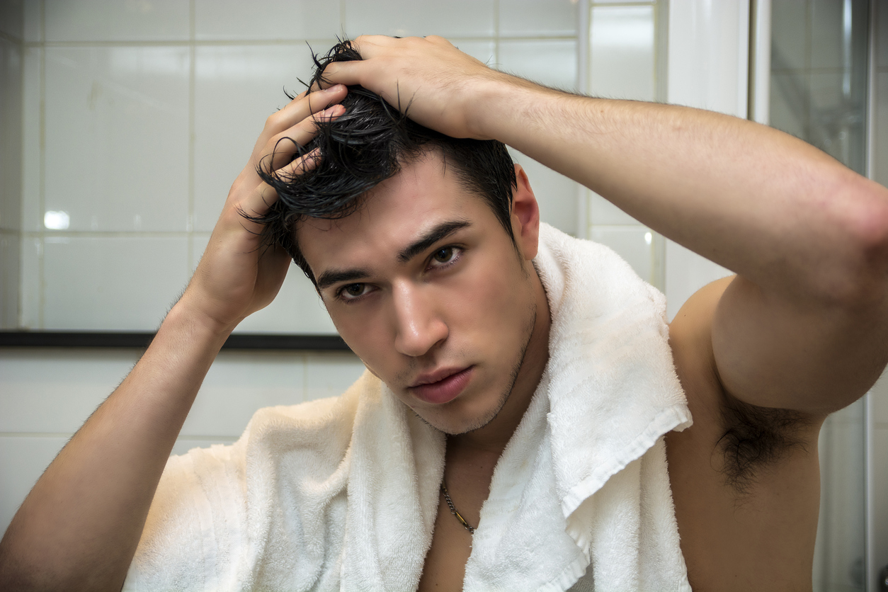 Gorgeous Man after Shower Holding his Head