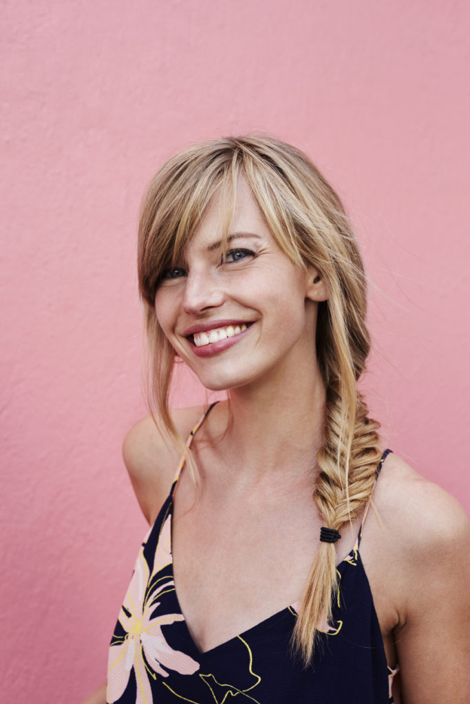 fishtail-braid-long-hair-blonde-woman-smiling-best-gym-hairstyles-toppik-blog